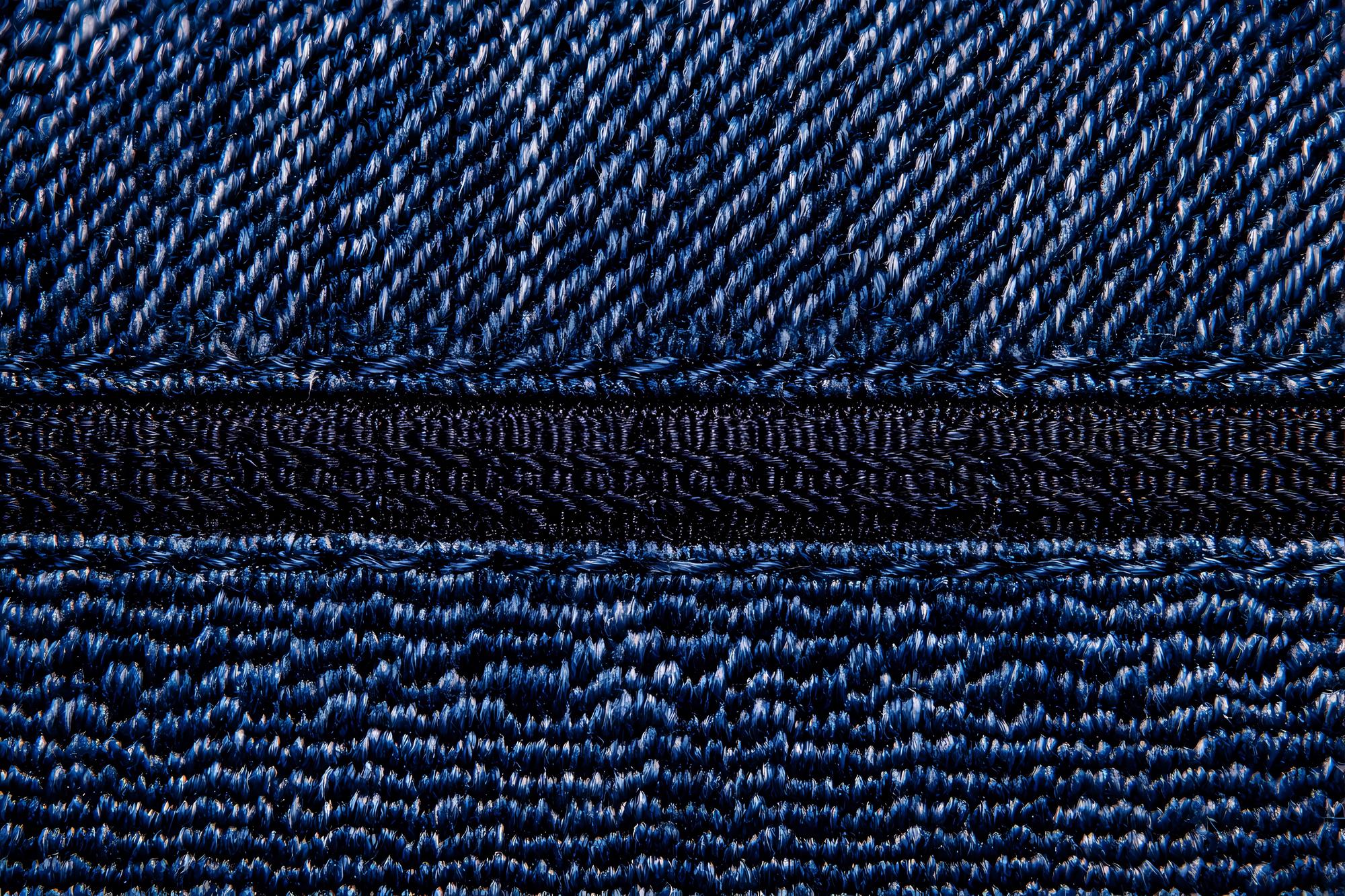 Close-up tonal threadwork on denim